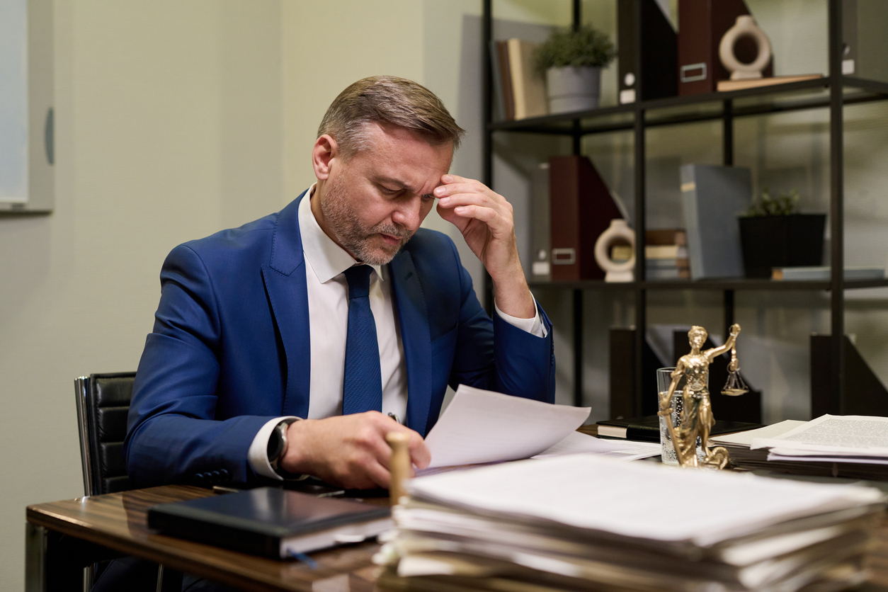 Attorney reviewing discovery documents for a Michigan business lawsuit