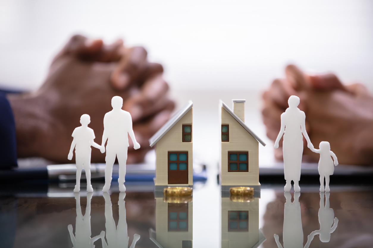 A prop house, rings, and cutouts of a family being divided between a couple during a divorce