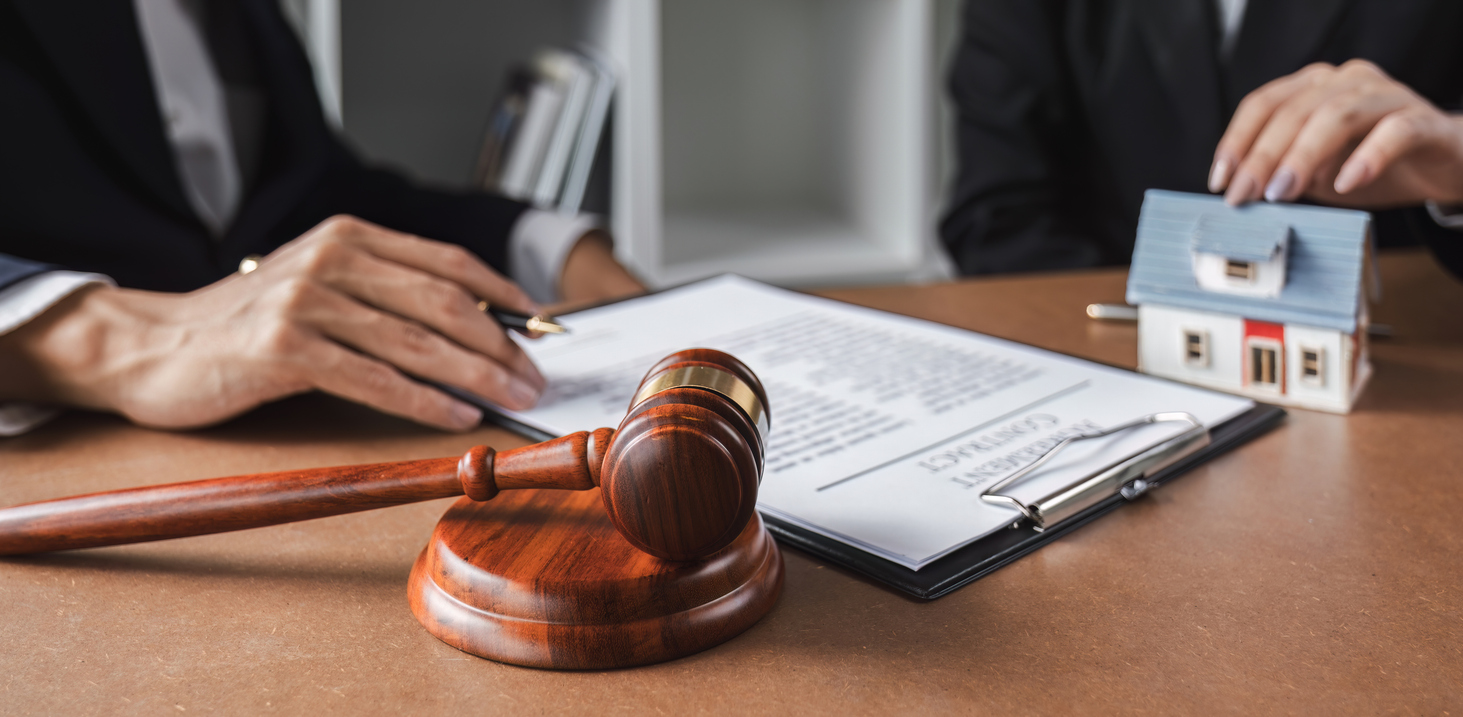 Gavel next to a real estate contract representing a Michigan breach of contract remedy